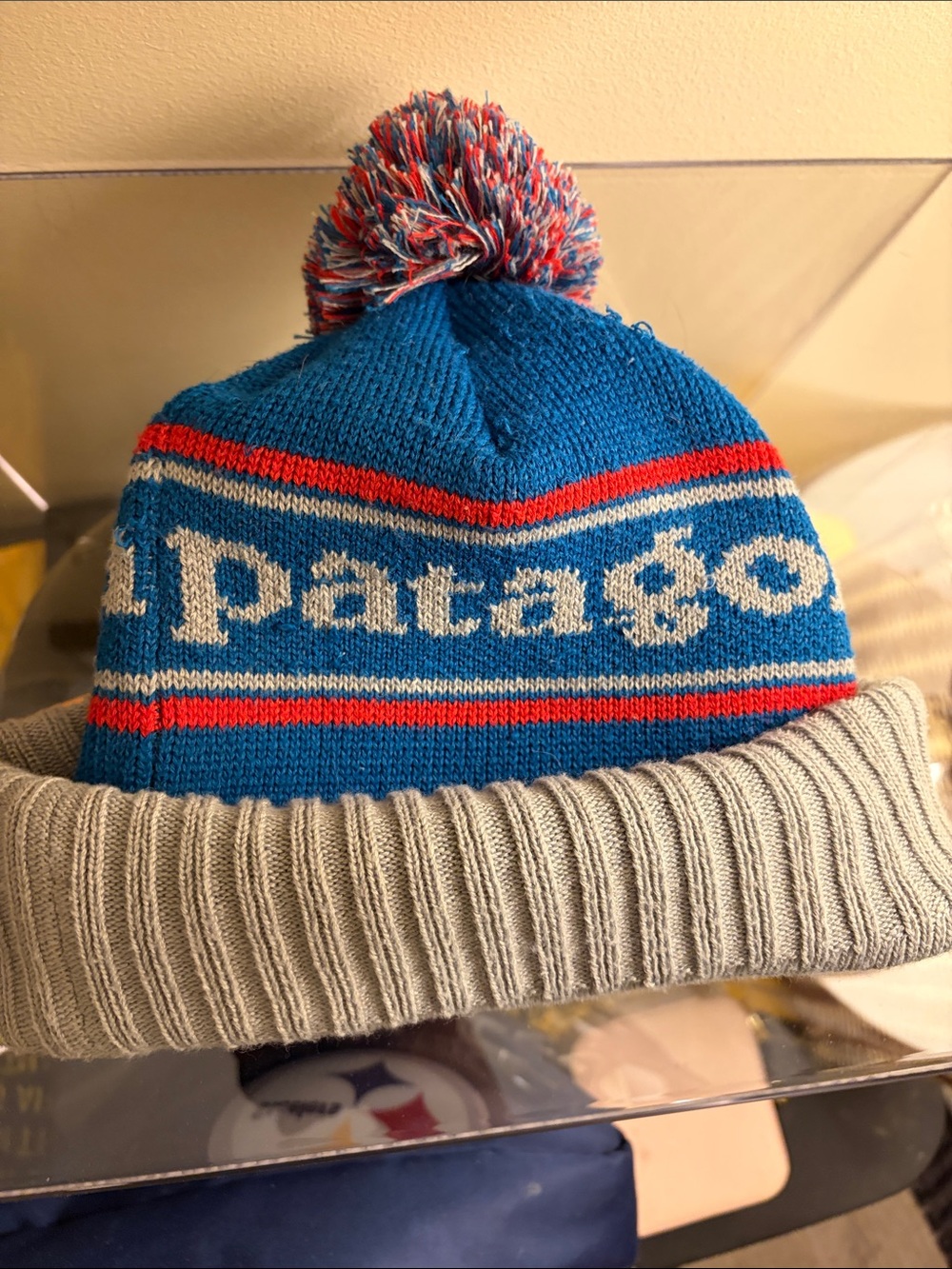 Patagonia Bright Blue Knit Pom Beanie with Gray Cuff and Red Accents